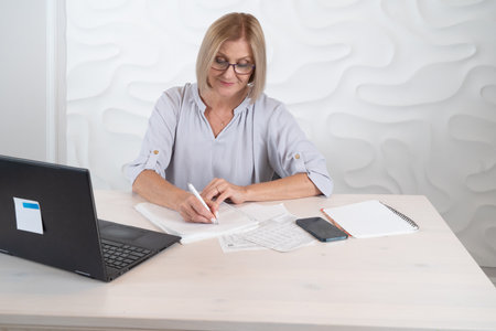 Senior woman working with modern laptop, technology and elderly lifestyle people conceptの写真素材