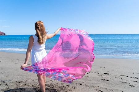 Girl jumping on the beach, beautiful woman on summer beach, freedom and relaxation conceptの写真素材