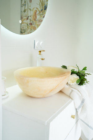 White tap and stone water basin in white bathroomの写真素材