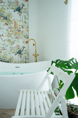 White bathroom with empty white chair, copy space for bath products and cosmeticsの写真素材