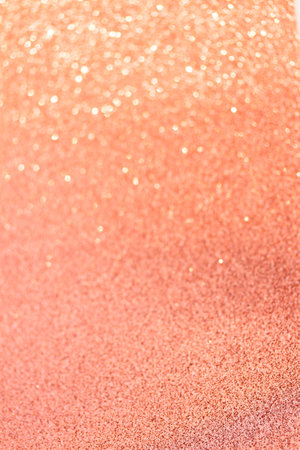 Christmas holiday glittering defocused Peach Fuzz background with bokeh lightsの写真素材