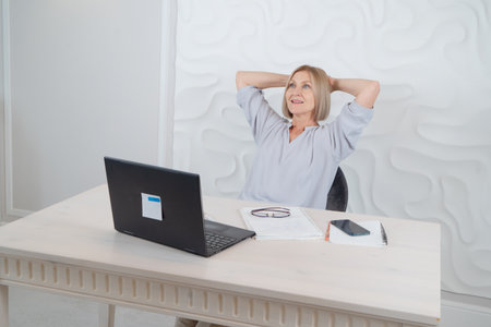 Senior woman working with modern laptop, relaxing moment, technology and elderly lifestyle people conceptの写真素材
