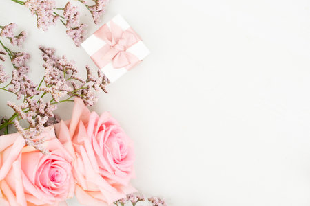 Rose fresh flower with present on table from above with copy spaceの写真素材