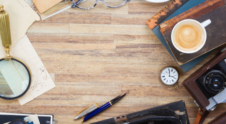 Books and glasses on wooden table desktopの写真素材