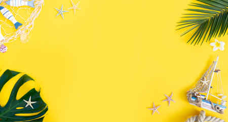 Summer flat lay scenery on yellow background banner with copy spaceの写真素材