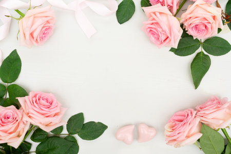 Rose fresh flowers frame for Valentines Day on table from above with copy space, flat lay sceneの写真素材