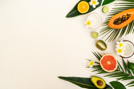 fresh fruits with green tropical leves flat lay border, summer diet backgroundの写真素材