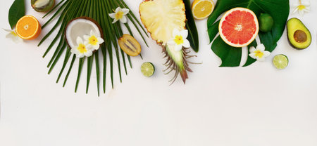 fresh fruits with green tropical leves flat lay top view border, summer diet background with copy spaceの写真素材