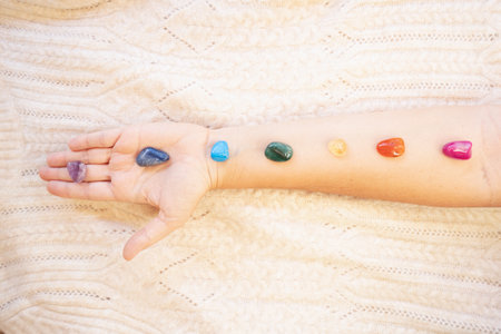 Healing crystals on female hand background, seven chakra stones.の写真素材
