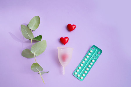 Menstrual cup over violet background, eco friendly and zero waste solutionの写真素材
