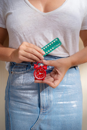 woman holding 21-day oral contraceptive pills, birth control and pregnancy planning conceptの写真素材