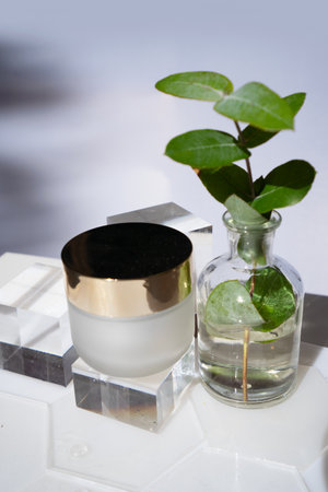 Laboratory tested face cream in white glass container on transparent podiumsの写真素材