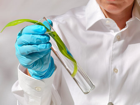 Science and nature concept, green laboratory with woman researcher inspecting test tubesの写真素材
