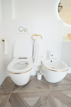 Modern white wc and bidet bowl in bathroom toilet close upの写真素材