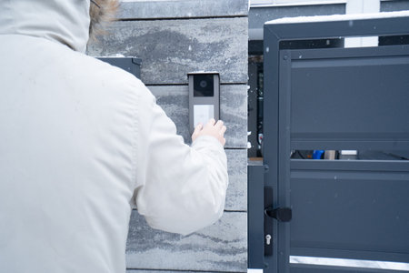 cctv surveillance system, home security camera outdoor, entrance intercome, man ringing at doorの写真素材