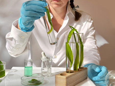 Science and nature concept, green laboratory with woman researcher inspecting test tubesの写真素材