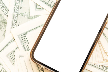 Financial app concept phone with blank screen over dollars billsの写真素材