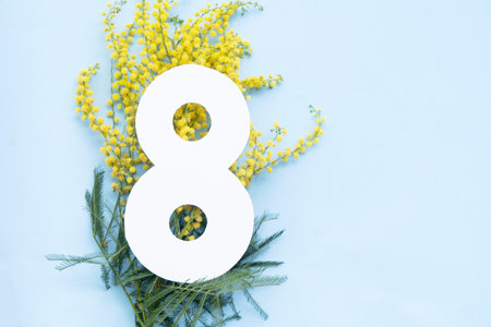 Mimosa yellow flowers on tender blue spring background, 8 march day festive background, mimose is traditional flowers for international womans day 8 of marchの写真素材
