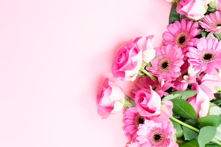 wedding or mothers day background, bouquet of roses and herberas over plain pink backgroundの写真素材