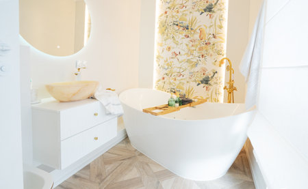 White bathroom with big window and big freestanding bathtubeの写真素材