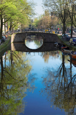 Bridge over canal with mirror reflections, Amstardam, Netherlandsの写真素材