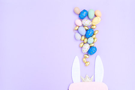 Easter scene with colored eggs and rabbits ears, copy spaceの写真素材