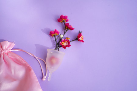 Menstrual cup over violet background, eco friendly and zero waste solutionの写真素材