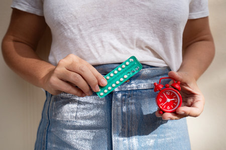 woman holding 21-day oral contraceptive pills, birth control and pregnancy planning conceptの写真素材