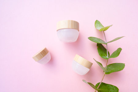 Natural cosmetics concept, cream jars over soft pink backgroundの写真素材