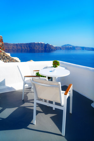 relaxing chairs and umbrella with view of caldera, Santorini, Greeceの写真素材
