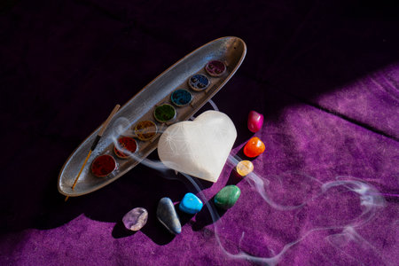 seven chakras signs and stone heart with flower of life pattern
