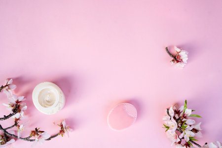 spring flowers with face cream over pink backgroundの写真素材