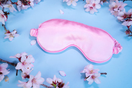 spring flowers with sleeping mask, sleep-wake disorders concept, insomnia therapy, sleep difficulties and deprivationの写真素材
