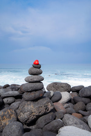 Balance stone tower on wild sea shoreの写真素材