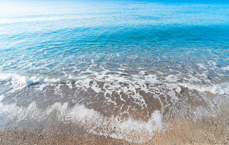 stone beach and turquiose water wave of cote dAzur at Nice at summer, Riviera, Franceの写真素材