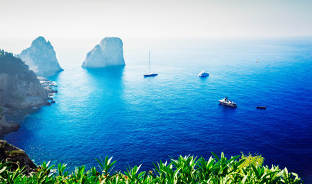 Famous Faraglioni cliffs and Tyrrhenian Sea blue water, famous Capri island, Italy, retro tonedの写真素材