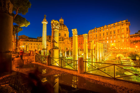 Forum - Roman ruins with column of Trajan illuminated at night, antique Rome Italyの写真素材