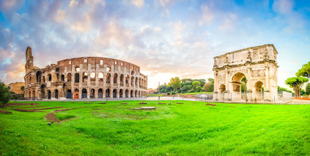 ruins of antique Colosseum and Arch of Constantine in sunise lights, Rome Italyの写真素材
