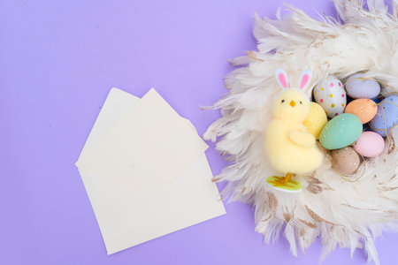Easter scene with colored eggs in nest over violet background, copy spaceの写真素材