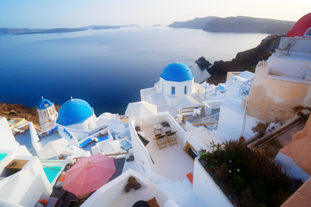 traditional greek village Oia of Santorini, with blue domes of churches and village street, Greeceの写真素材