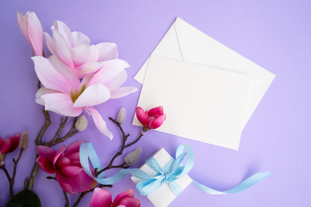 Blooming pink magnolia tree branch with flowers against violet background, copy spaceの写真素材
