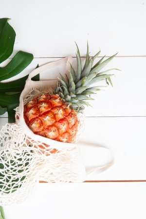 pinapple on white wooden table in bagの写真素材