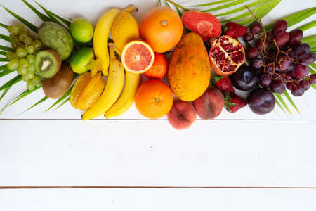 Summer mix of tropical fruits over white wooden backgroundの写真素材