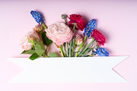 Flowers layout with copy space for cards, wedding invitation, posters, save the date or greeting design. Layout made of ranunculus flowers on pink background.の写真素材