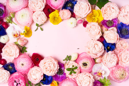 Flowers composition. Frame made of roses, orchids and ranunculus flowers on white background. Flat lay, top viewの写真素材