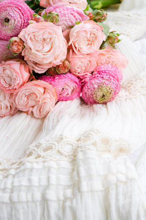 Female dress with fresh pink rununculus bouquetの写真素材