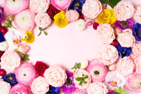 Flowers composition. Frame made of roses, orchids and ranunculus flowers on white background. Flat lay, top viewの写真素材