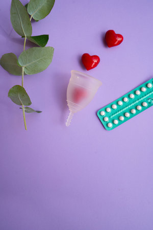 Menstrual cup over violet background, eco friendly and zero waste solutionの写真素材