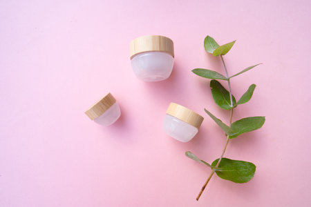 Natural cosmetics concept, cream jars over soft pink backgroundの写真素材
