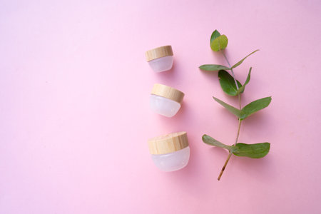 Natural cosmetics concept, cream jars over soft pink backgroundの写真素材